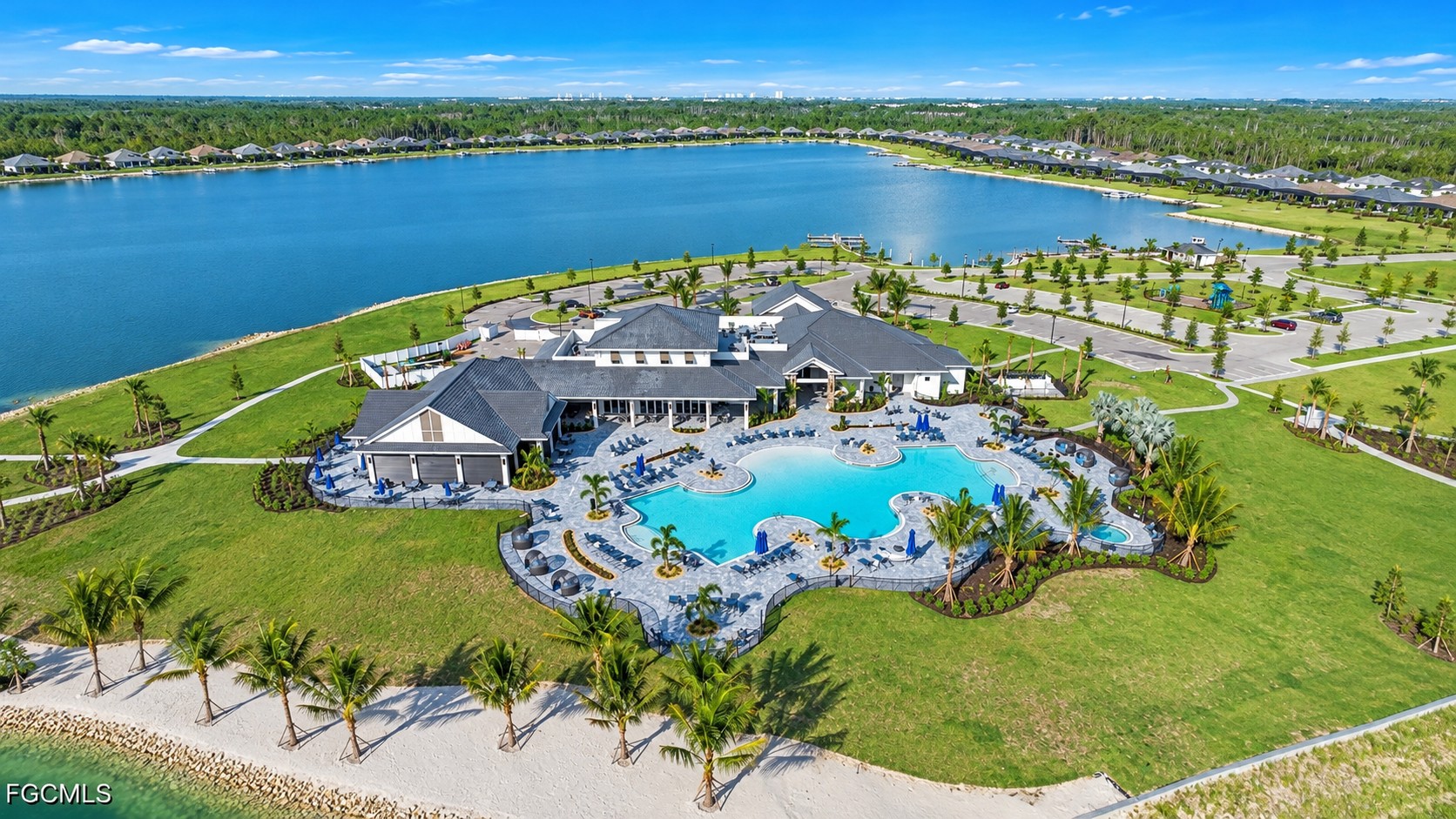 Aerial view of the WildBlue lakefront clubhouse, resort pool, and surrounding community